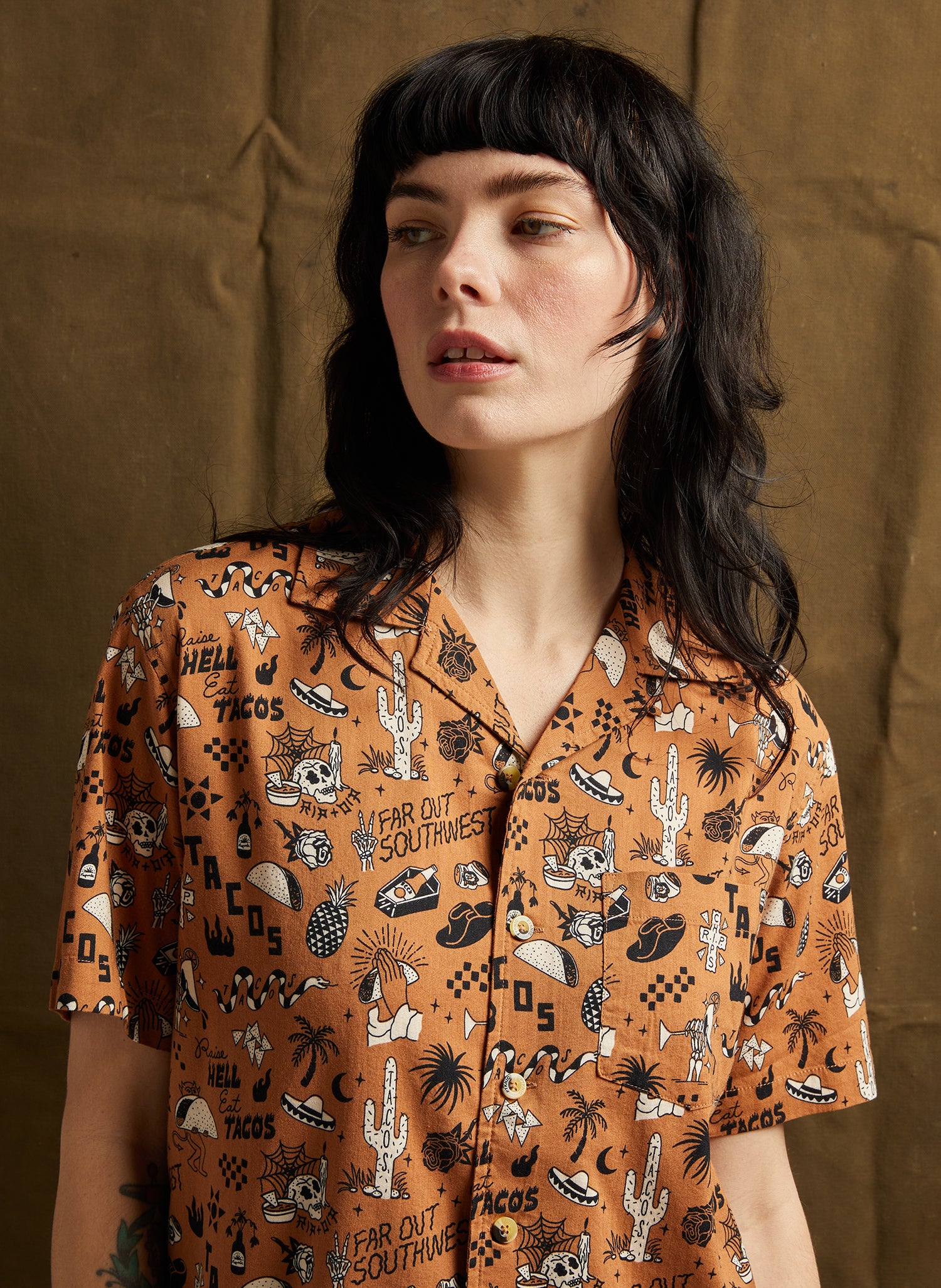 Raise Hell Eat Tacos Button-Up in Rust with Western and tattoo flash-style all-over print, featuring soft 55% cotton, 45% rayon blend and tortoise buttons.
